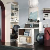 Modern home office with BILLY bookcase, foldable table, chair, and decor.