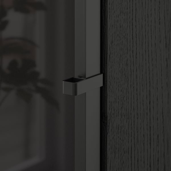 Close-up of a dark BILLY bookcase door handle. Sleek, modern design, smooth finish. Part of a versatile, high-quality storage solution.