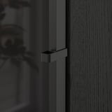 Close-up of a dark BILLY bookcase door handle. Sleek, modern design, smooth finish. Part of a versatile, high-quality storage solution.