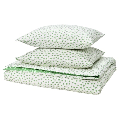 The BJÖRKGRÅMAL bedding set, featuring white sheets with green dots, made from cotton and viscose, neatly folded.