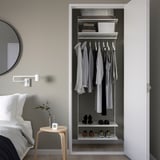 Modern bedroom with wall-mounted BOAXEL storage & bedside table.