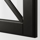 Close-up of BODBYN black glass door frame with sleek, bevelled edges and smooth surface.