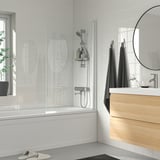 Modern bathroom with BROGRUND silver shower mixer, wooden vanity, and plant.