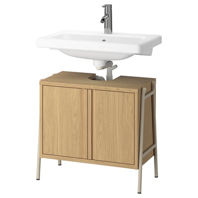 Wooden bathroom vanity with white sink, chrome faucet.