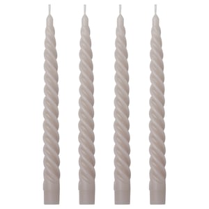 Four grey spiral candles in a row, each twisted and tall, made of paraffin and plant wax, standing upright.