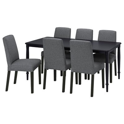 Modern black dining set with six gray cushioned chairs and rectangular table.