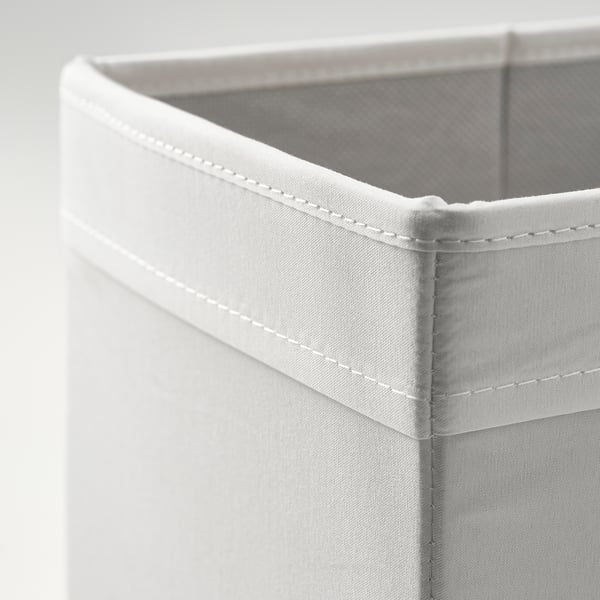 Close-up of a white fabric storage box edge, showing sturdy stitching and quality material.