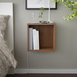 Minimalist wooden wall-mounted cube shelf, brown, holds books and decor, neat and compact.