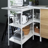 Modern white kitchen shelf organizer with multiple appliances, including a toaster, mixer, and pots.