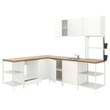 Modern white kitchen unit with light wood counter, featuring open shelves, cabinets, and a sink.