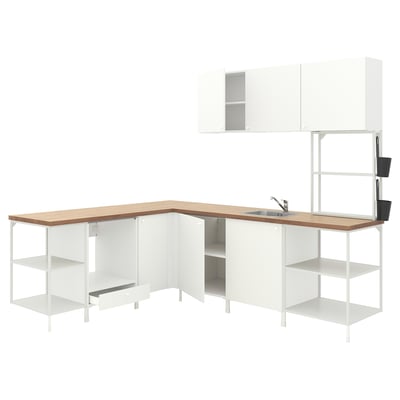 Modern white kitchen unit with light wood counter, featuring open shelves, cabinets, and a sink.