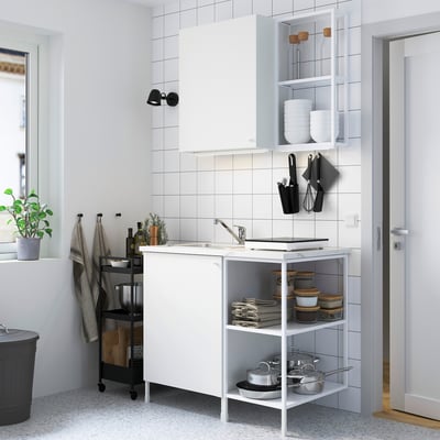 Modern compact white kitchen: ENHET. Sink, shelves, and cabinet, neatly organized with clean design. Fits small spaces, ideal for efficient kitchens.