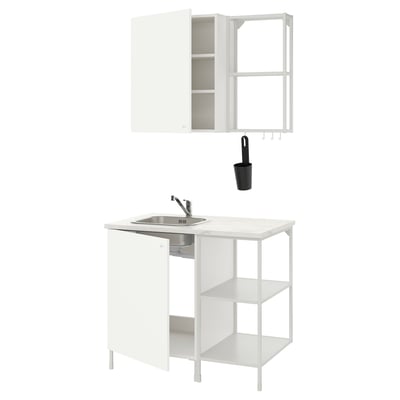 White ENHET kitchen setup: sink, cabinet, shelves, black utensil holder. Modern, minimalist design.