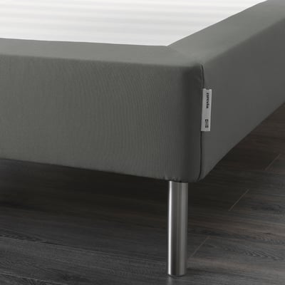 Gray fabric mattress base with metal legs, elevates bed for easier access.