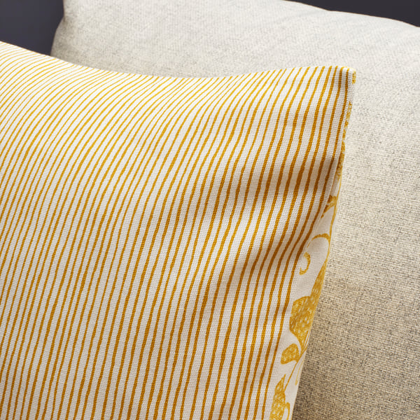 Striped cushion cover with delicate pattern, zipper detail, high-quality cotton fabric.