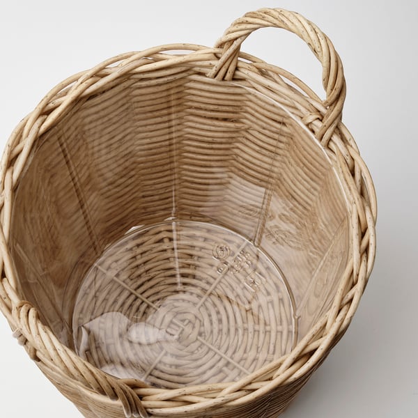 Handwoven wicker basket with durable plastic lining, featuring sturdy handles.