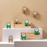 Six FLODKRÄFTA clocks: natural cork & green. Modern design, three table, two boxed, one wall.