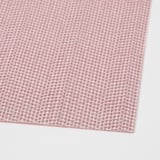 A close-up of a woven pink and gray place mat, showcasing its intricate pattern and high-quality plastic material.