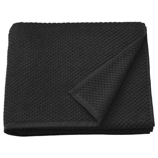 Black folded GULVIAL cotton towel, soft and textured, medium thickness.