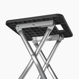 Foldable stool with metal frame, plastic seat, sturdy design.