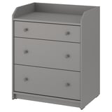 A gray HAUGA chest with three drawers. Its made of particleboard and has simple, rounded knobs. Ideal for various rooms and organizes items neatly.