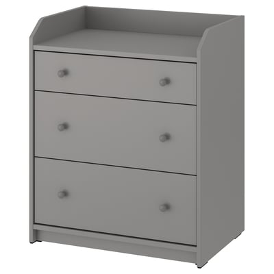 A gray HAUGA chest with three drawers. Its made of particleboard and has simple, rounded knobs. Ideal for various rooms and organizes items neatly.