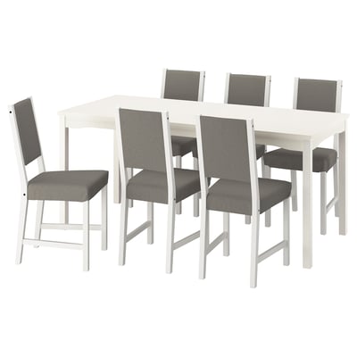 White håuga dining set with 6 gray cushioned chairs.