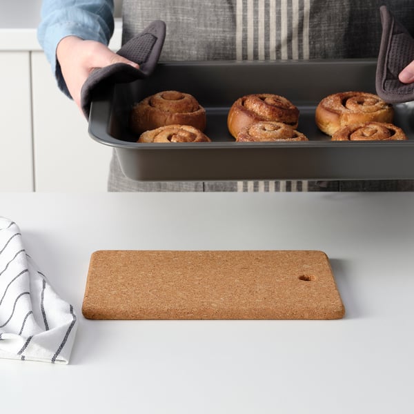 Removing cinnamon rolls from oven.