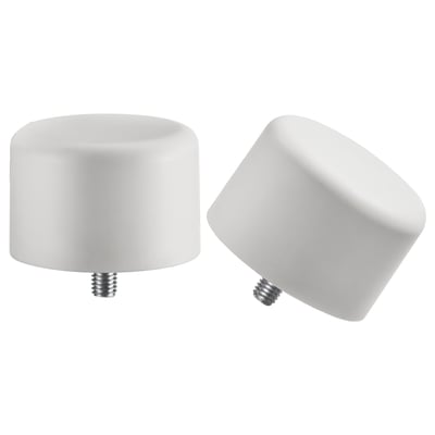 Two white circular finials, one upright, one tilted, with screws at the bottom. Minimalist design in recycled plastic.
