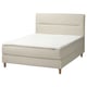 Modern beige bed with soft headboard, wooden legs, and white mattress.