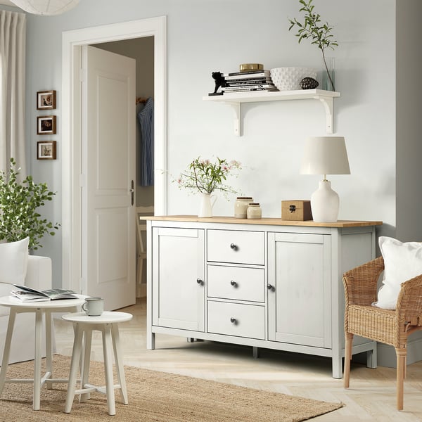 HEMNES sideboard with lamp, vases, books, and plant in a cosy living room.