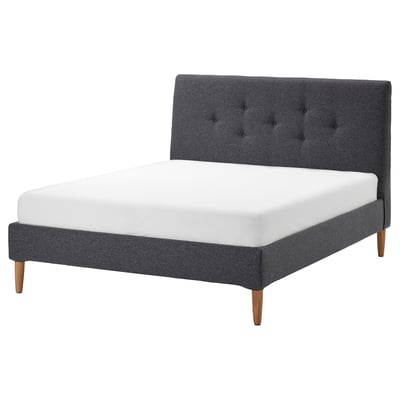 Modern grey upholstered bed with tufted headboard and wooden legs.