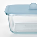Clear glass container with blue silicone vacuum lid, designed for food storage and oven use.