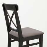 Dark wooden chair with upholstered seat, showing sturdy craftsmanship and modern design.