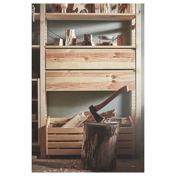 IVAR storage shelves in natural wood with axe and chopped logs.