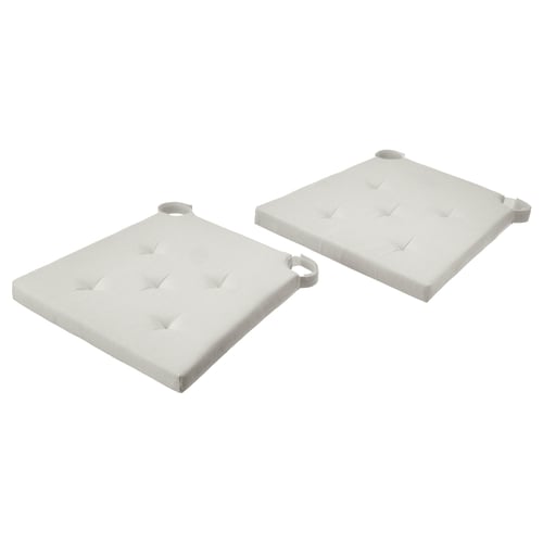 Two light-colored, square cushions with looped edges for a chair, offering comfort and style.