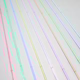 Colourful led light strips with usb connectors, displaying multiple colours and patterns, arranged diagonally on a light background.