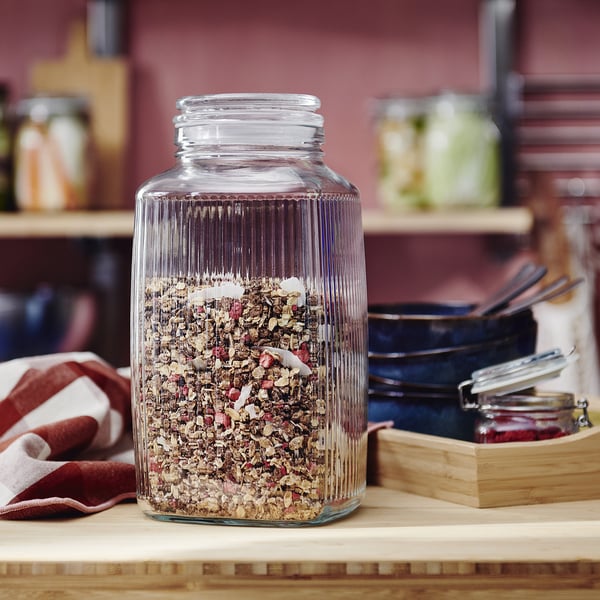 KÖSSEBÄR glass jar with herbs on counter.