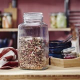 KÖSSEBÄR glass jar with herbs on counter.
