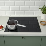 Modern kitchen with black induction stove.