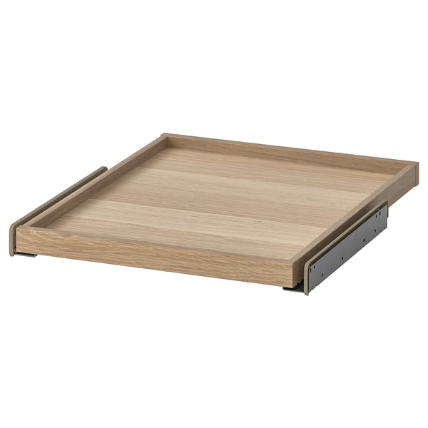 An ikea KOMPLEMENT pull-out tray. Its light brown, rectangular, with wooden texture and metallic runners. Ideal for wardrobe storage.