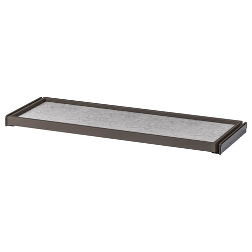 A KOMPLEMENT pull-out shelf in brown with a white felt interior, designed for organising wardrobe space.