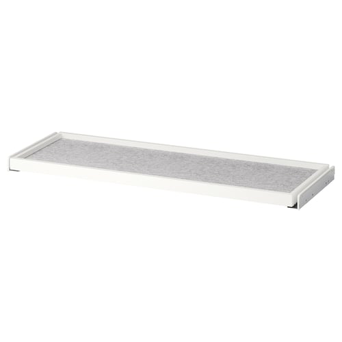 A white KOMPLEMENT pull-out shelf in a wardrobe, featuring a grey felt drawer mat. Rectangular, minimalist design for organising space.