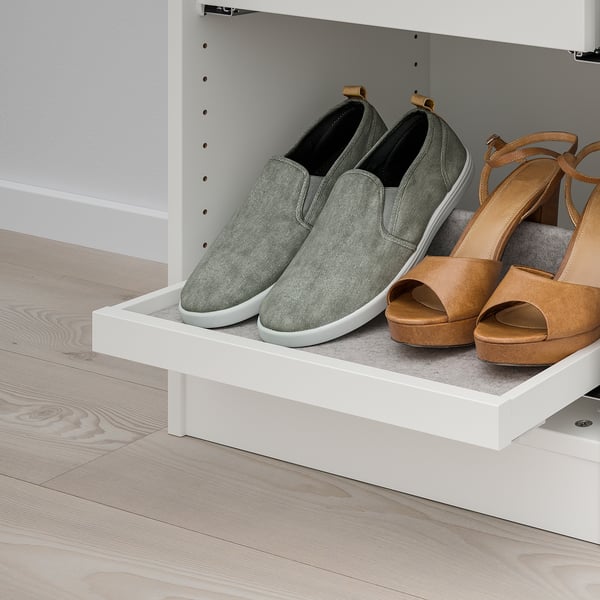 White shelf with pull-out tray holding gray sneakers and brown sandals.