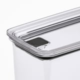 Close-up of clear plastic food container with secure, push-button lid.