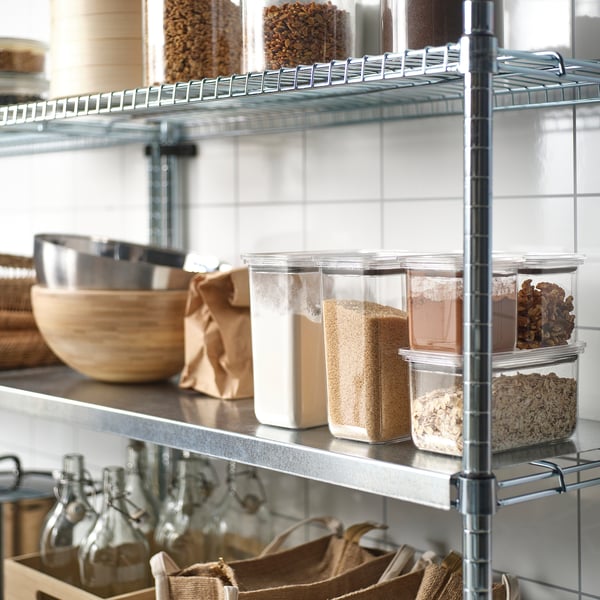 Shelf with clear jars storing grains and nuts, airtight lids visible, easy to see contents and stack.