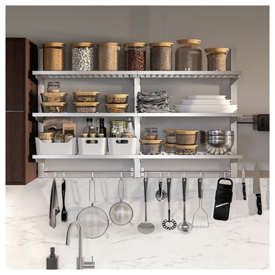 Modern kitchen with KUNGSFORS stainless-steel storage. Shelves hold jars and containers, while hooks below hang utensils.