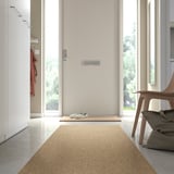 Light beige LÄTTBETONG rug in entryway, near door, smaller than chair.