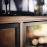 Modern LANESUND cabinet with glass door, wood, metal accents.