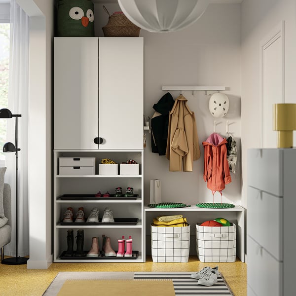 Modern entryway with LASTARE storage, shoes, bags, jackets, and decor.